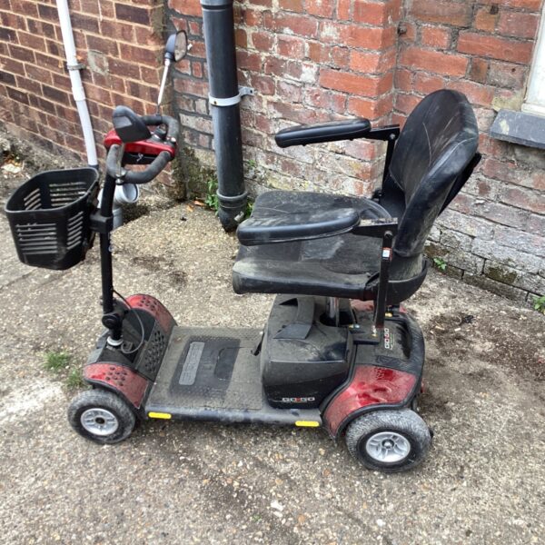 Red Pride Go Go Elite Traveller Plus mobility scooter with basket.