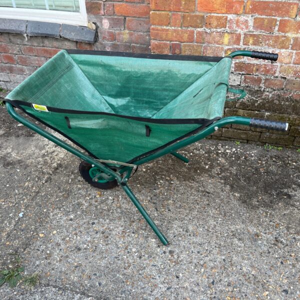 Green Relaxdays foldable wheelbarrow for garden use.