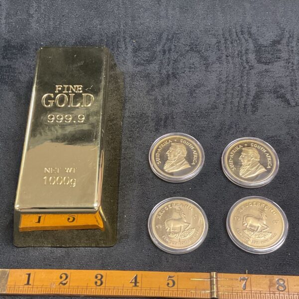 Replica gold ingot and 1967 Krugerrand coin for collectors.