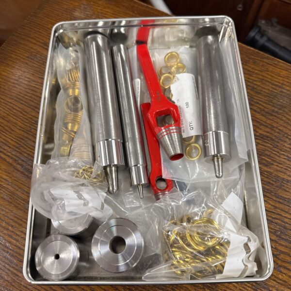 Vintage ringlet punch set with lever tool and punches.