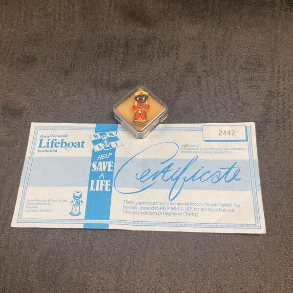RNLI Golly badge with certificate, a vintage collectible pin.