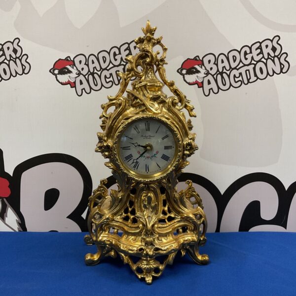 Ornate gilded brass Robert Grant mantle clock with floral details.