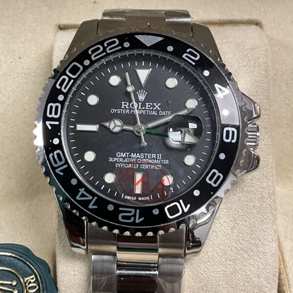 Close-up of a Rolex GMT-Master II quartz wristwatch with blue and red bezel.