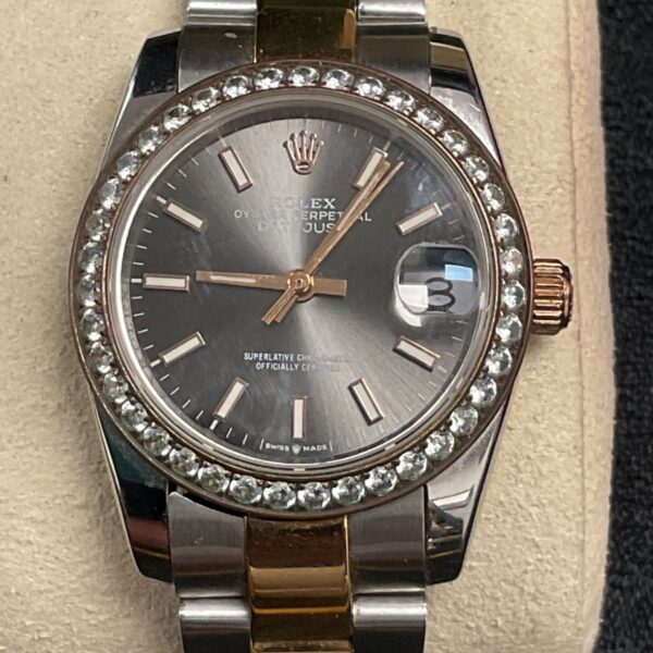 Close-up of Rolex style quartz wristwatch with diamond bezel.