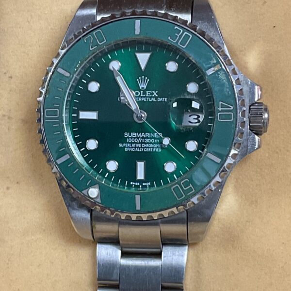 Rolex STYLE Submariner watch with green dial and stainless steel bracelet.