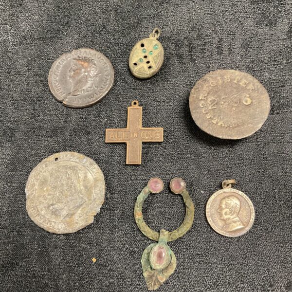 Collection of Roman and medieval artefacts, including coins and jewellery.