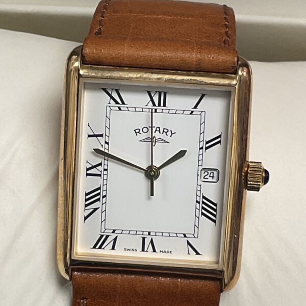 Close-up of the white dial on a vintage 9ct gold Rotary watch.