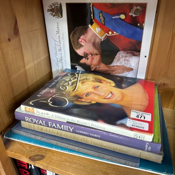Stack of commemorative royal books including Princess Diana biography.