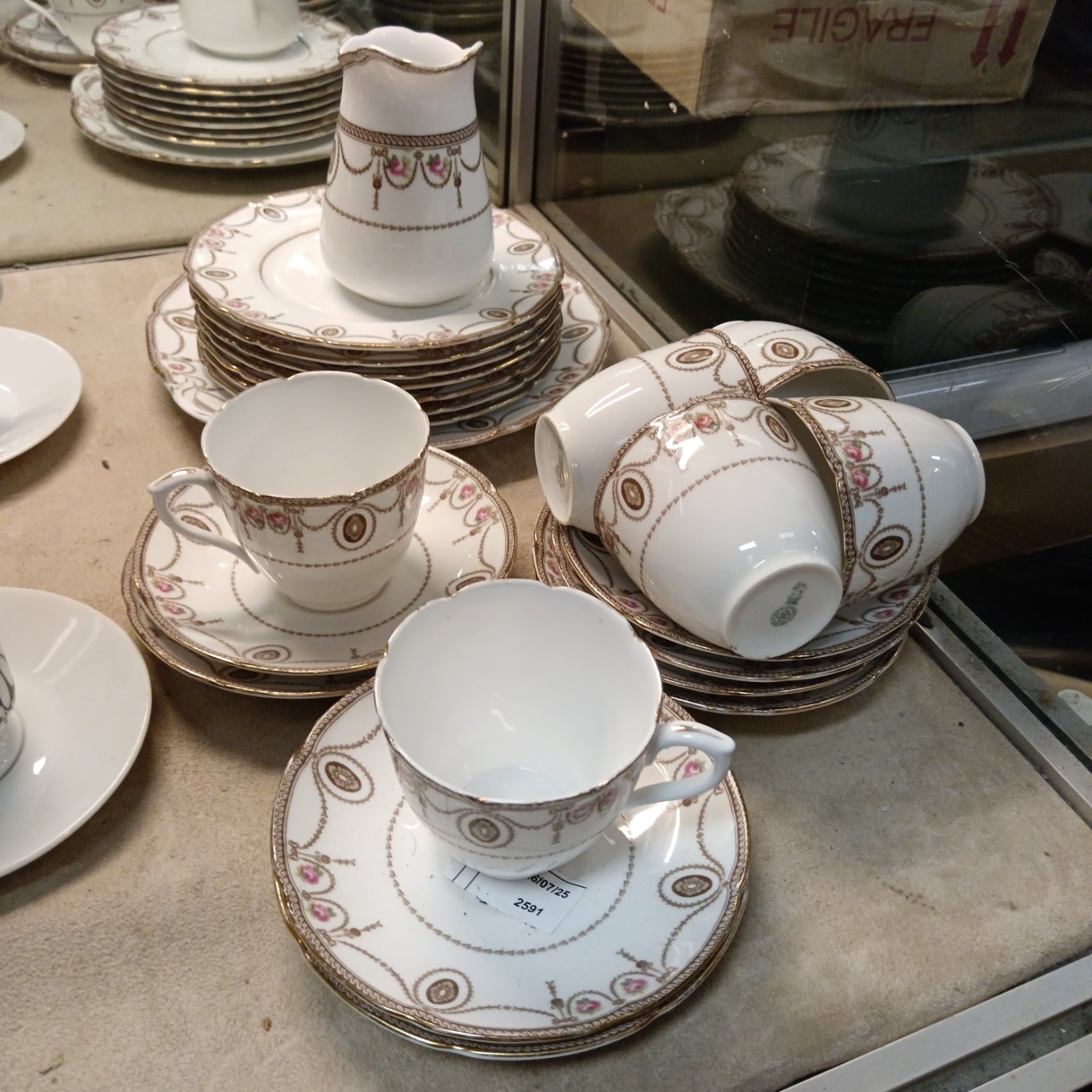 Royal Doulton teacup set with floral pattern and gold trim.