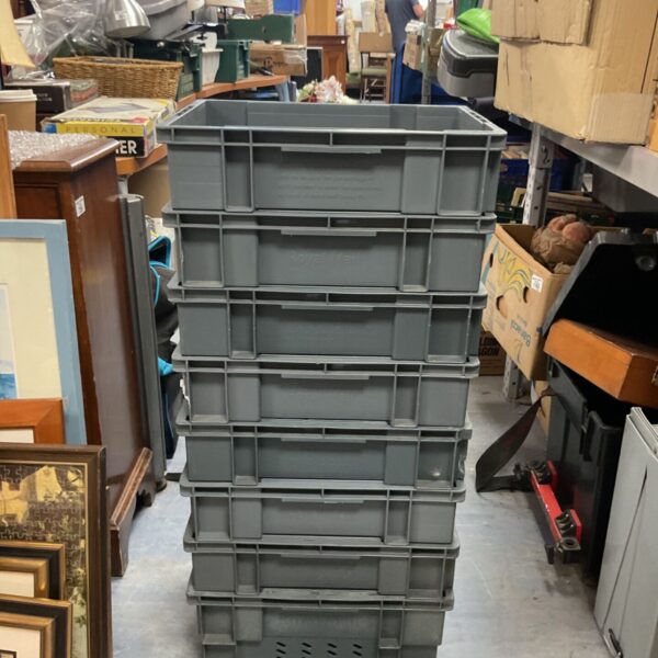 Stack of grey Royal Mail storage boxes for postal sorting.
