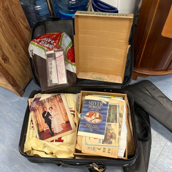 Suitcase filled with vintage royal family memorabilia and collectibles.