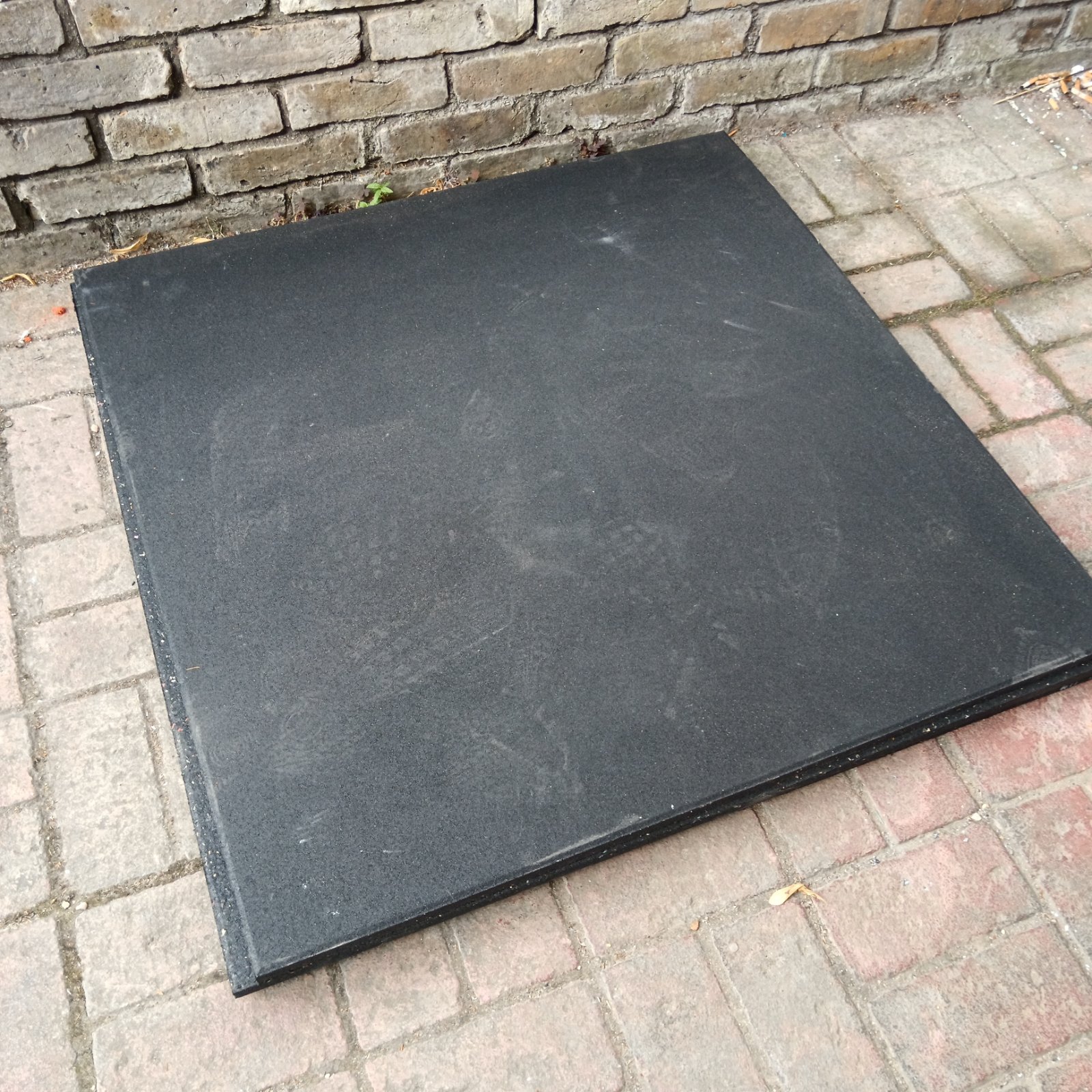 Close-up of a textured rubber gym mat for fitness flooring.