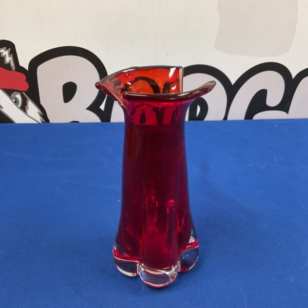 Ruby red art glass vase with flared design.