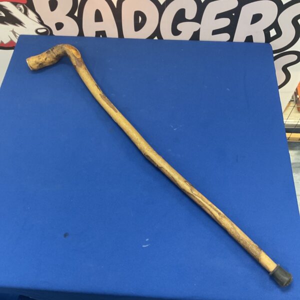 Rustic walking stick with a traditional shepherd's crook handle.