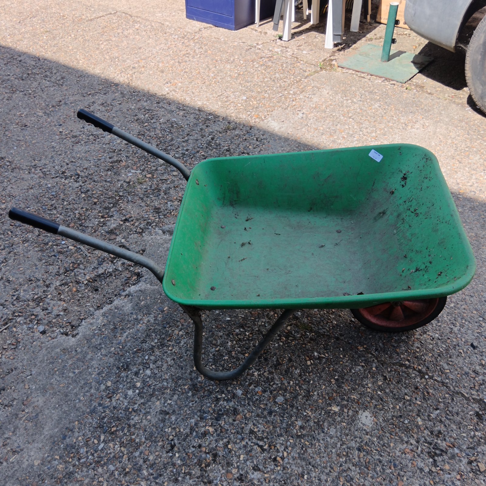 Green Ryland garden wheelbarrow with metal frame and wheel.