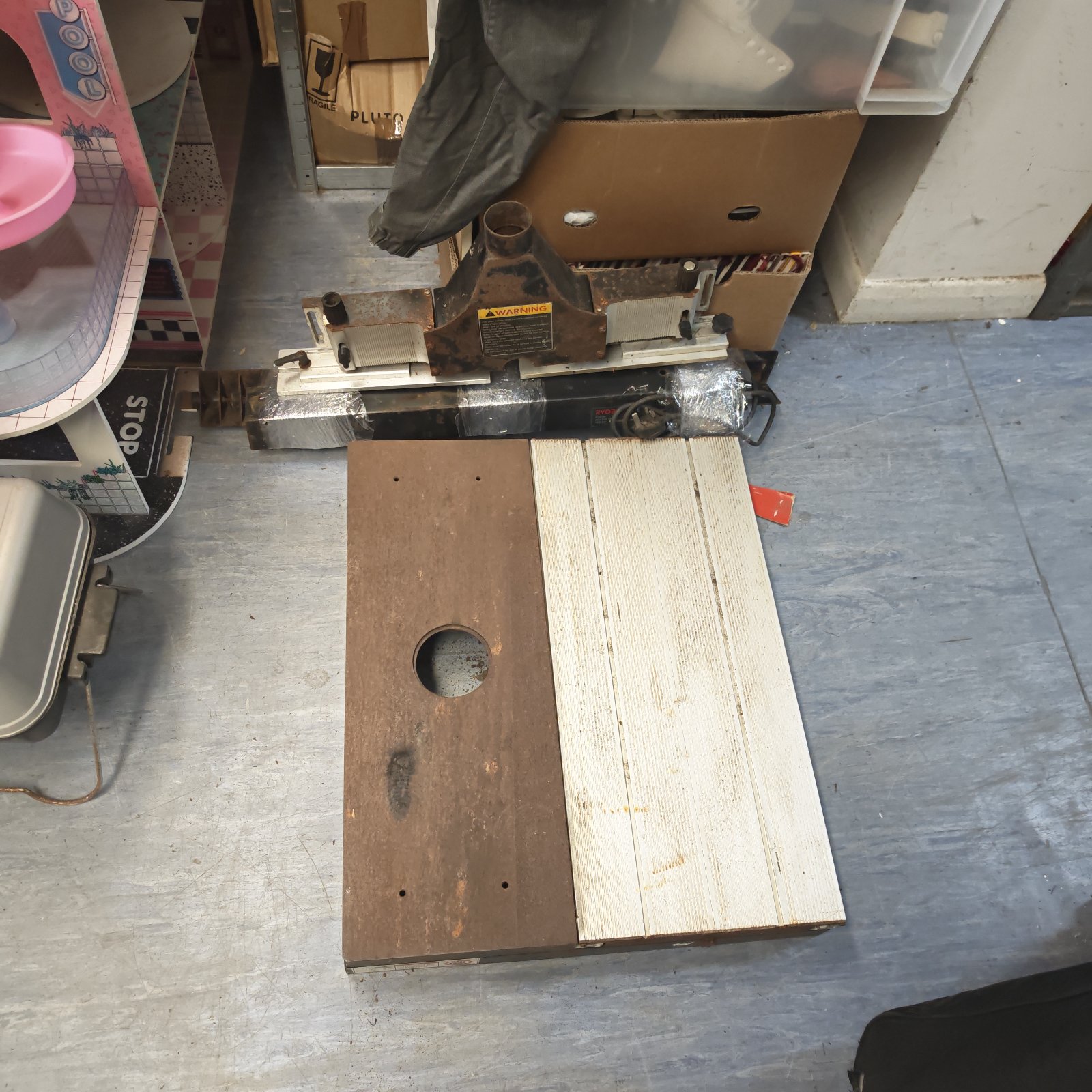 Used Ryobi router table with a wooden tabletop and central opening.