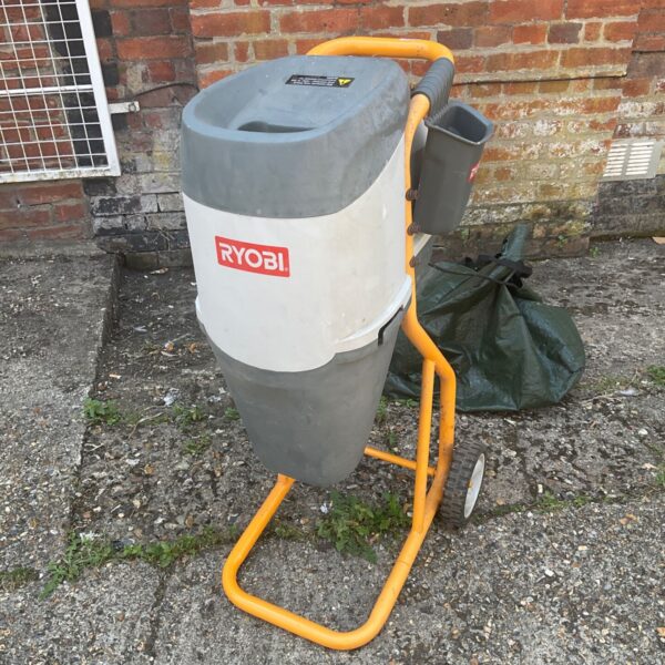 Yellow Ryobi garden shredder with wheels for reducing garden waste.