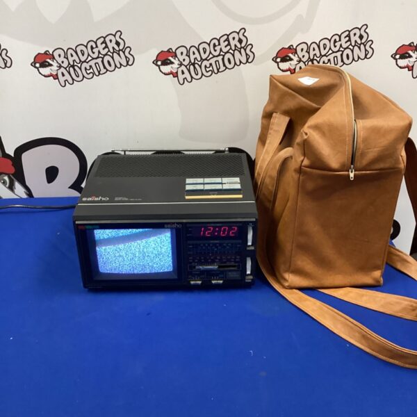 Vintage Saisho portable colour TV with radio and alarm clock.