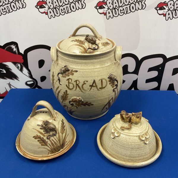 Salt glazed pottery set with mouse design, including bread bin and dishes.