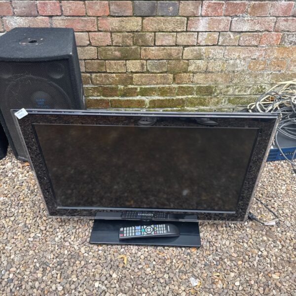 Samsung 32 inch flat screen TV with remote control.