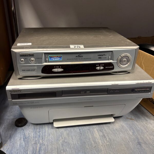 Samsung VHS player stacked with Sony DVD player and HP printer.