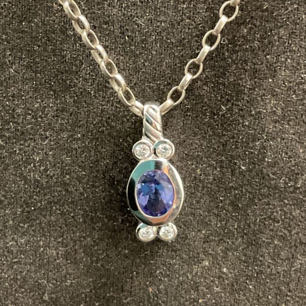 White gold sapphire and diamond pendant on silver chain.