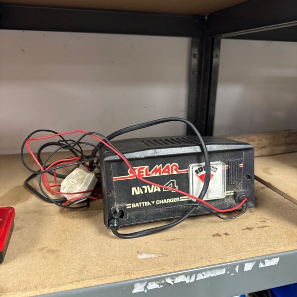 Vintage Selmar Nova 4 battery charger with red and black leads.