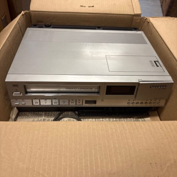 Vintage Sharp VC-381H VHS player in grey casing.