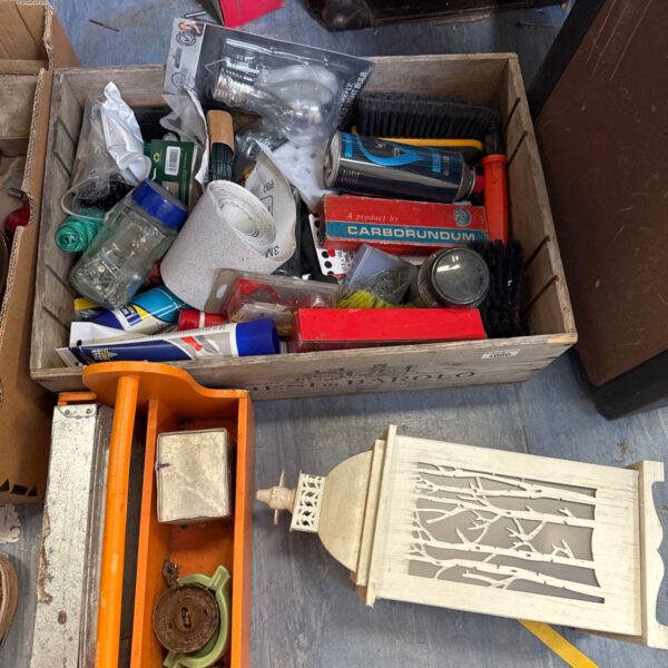 Shed clearance lot with lantern and garden tools.