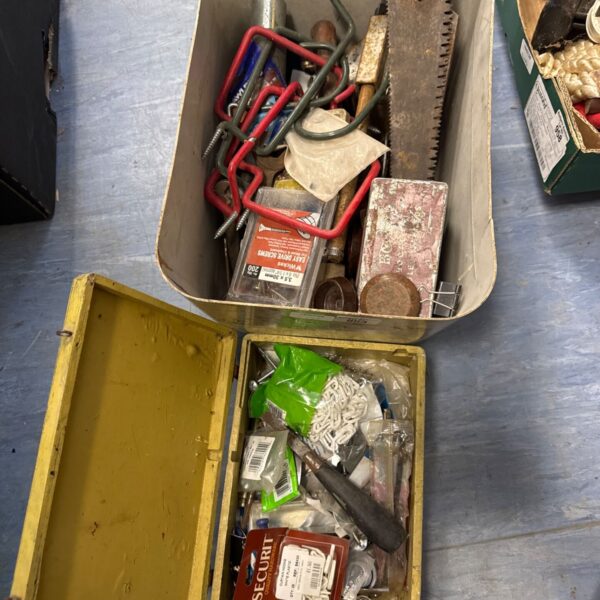 Shed clearance lot with vintage saw and assorted tools.