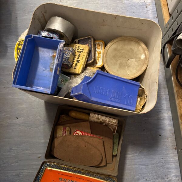 Vintage shed clearance lot with old tobacco packaging and ephemera.