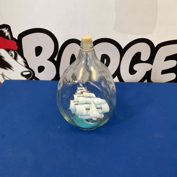 Vintage ship in a bottle with ripple glass design.