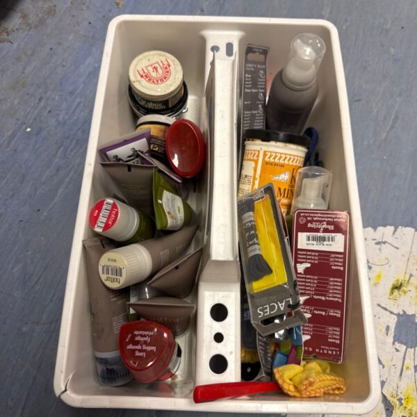 Tray of vintage shoe care products including polish and creams.