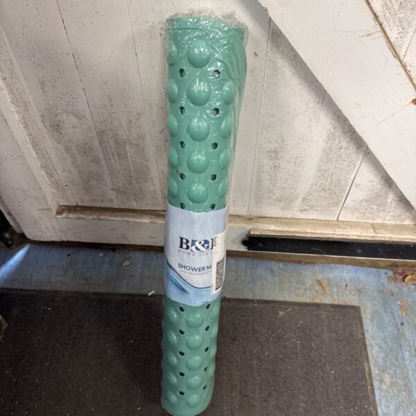 New shower mat in packaging for bathroom safety.