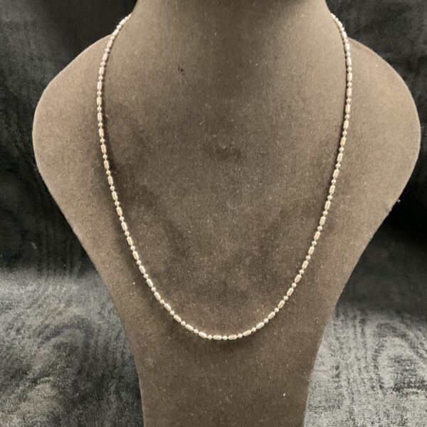 Delicate 925 silver ball link necklace on a display bust.