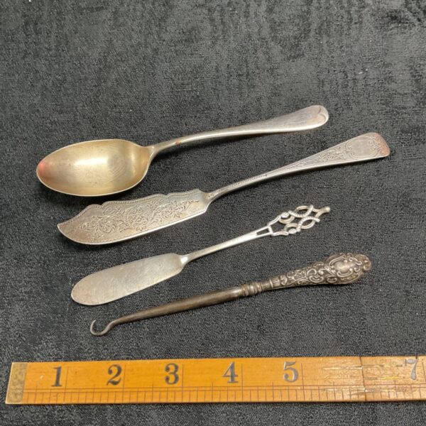Antique hallmarked silver cutlery collection with Victorian detailing.