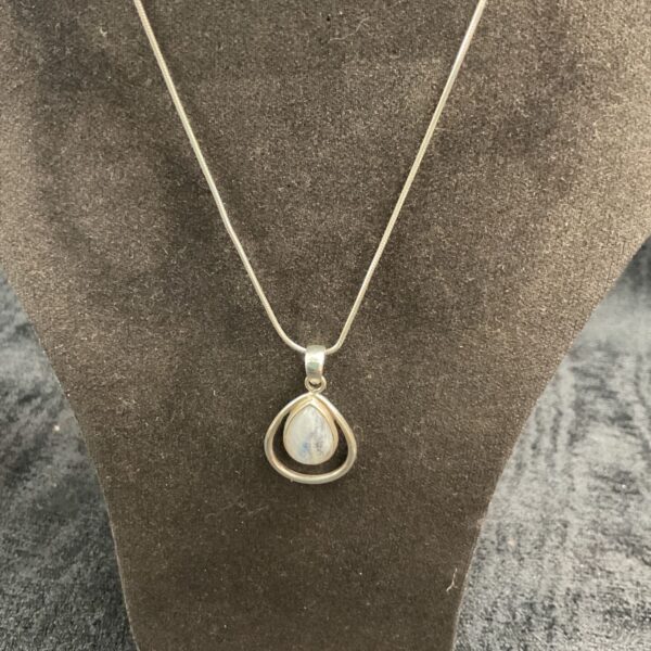 Silver moonstone pendant necklace on a chain.