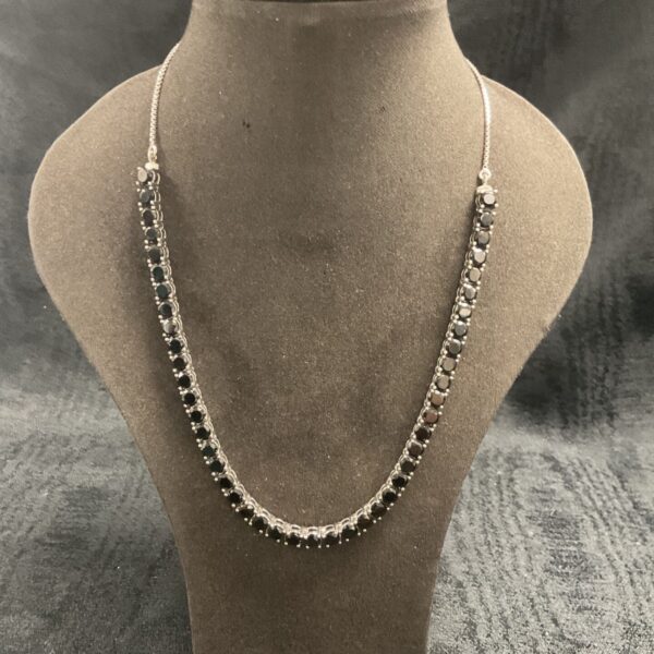Close-up of 925 silver onyx multi-stone necklace on display.