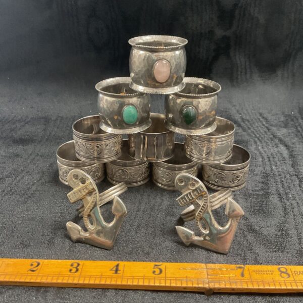Vintage silverplate napkin ring collection with assorted designs.