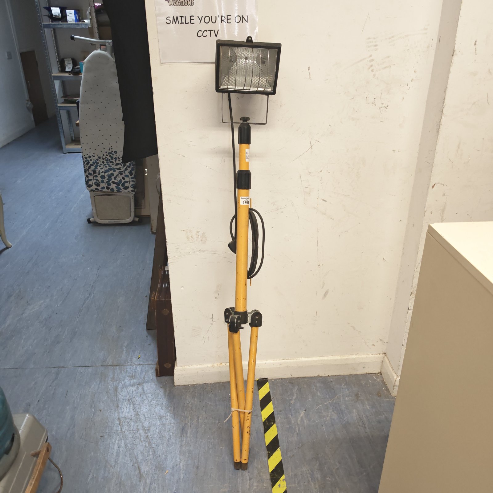 Portable site LED light with tripod base for construction or outdoor use.