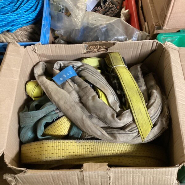Mixed lot of colourful slings and straps in a cardboard box.