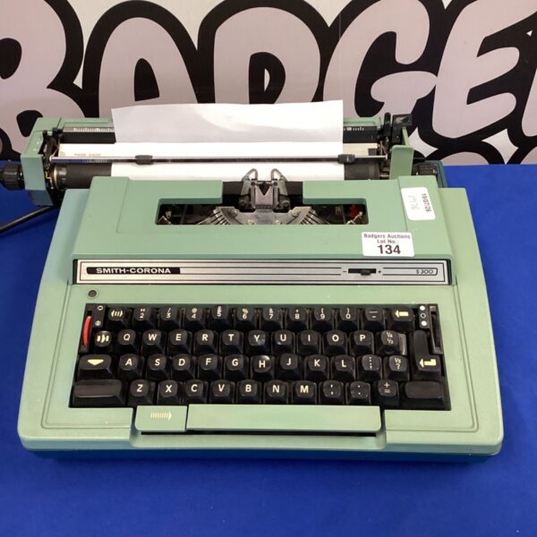 Vintage green Smith Corona typewriter, a collectible office machine.