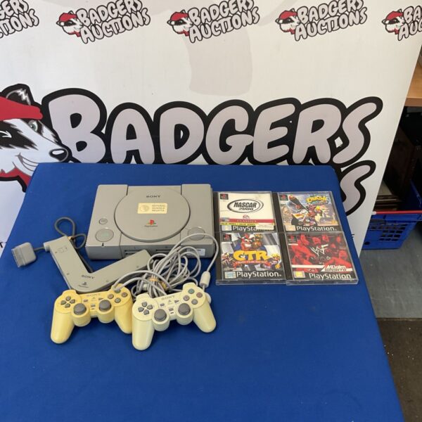 Vintage Sony PlayStation 1 console with included games.