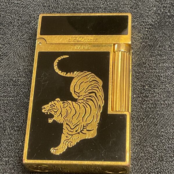 Vintage ST Dupont Paris lighter with a gold tiger design.