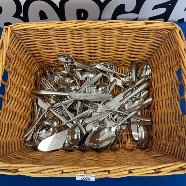 Basket of stainless steel cutlery for dining and kitchen use.