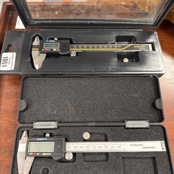 Stainless steel micrometer with metric and imperial scale.