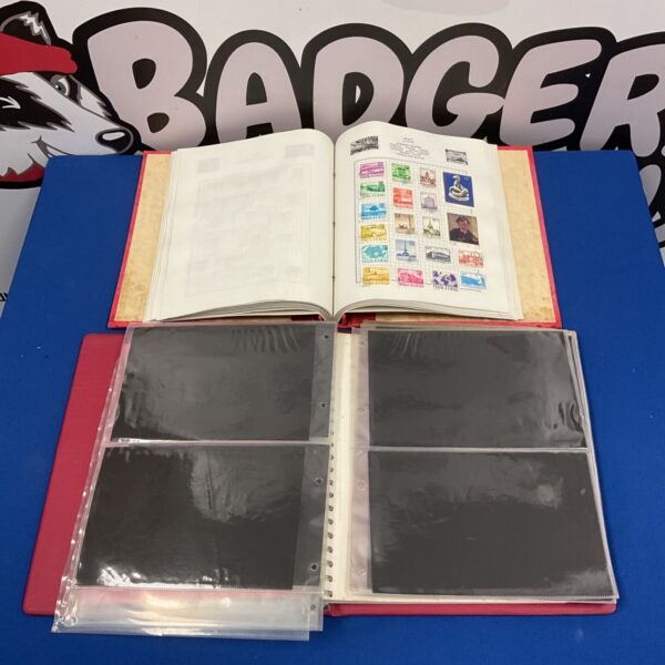 Open stamp album with stamps and empty first day cover album.