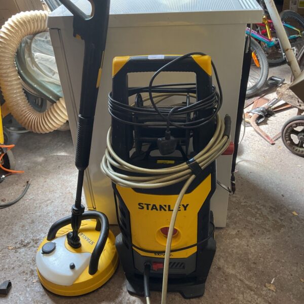 Yellow Stanley pressure washer with hose and handle.