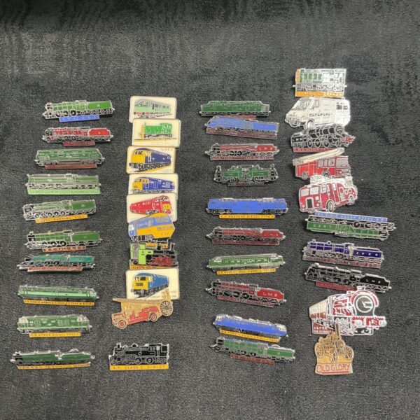 Assorted vintage steam locomotive and railway metal pin badges.