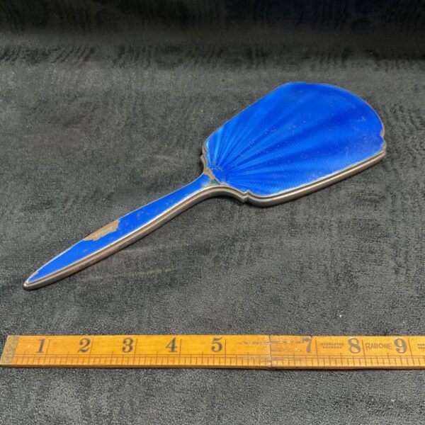 Antique sterling silver hand mirror with blue enamel detailing.